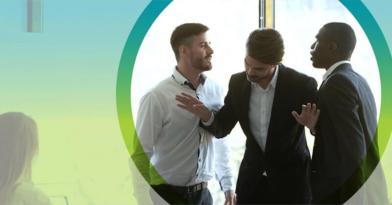 Photo of three men in a professional setting practicing conflict resolution.