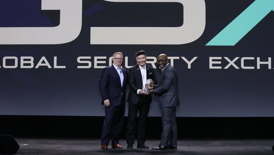 ASIS CEO Peter J. O’Neil and ASIS President Malcolm C. Smith, CPP, present Danny Chan, director of regional security for Mastercard, with the President’s Award of Merit on stage at GSX 2022.