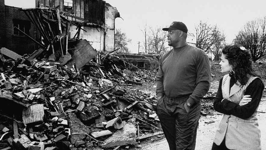 Former football player Reggie White and his wife Sara walked past burnt rubble of the Inner City Church where he served as an assistant pastor at the church.