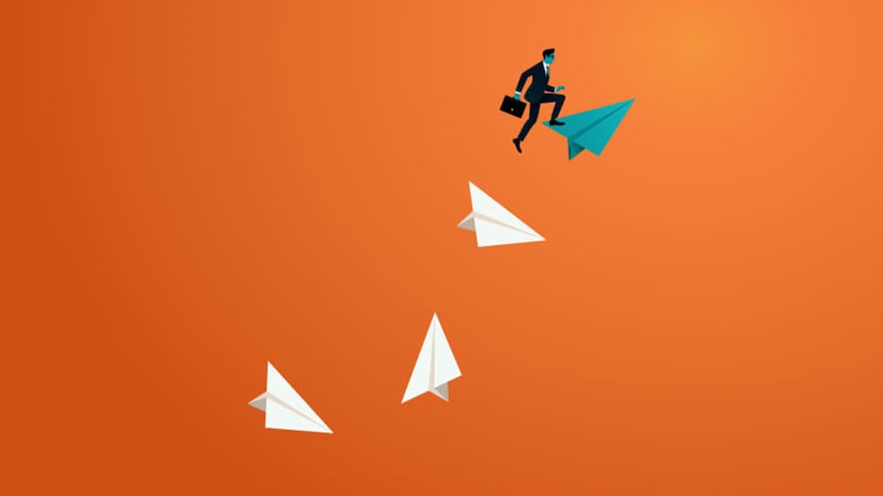 Security professional holding a briefcase stepping onto a teal paper airplane, soaring above three falling white paper airplanes on a gradient orange background.