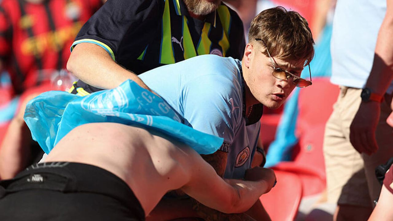 Manchester City fans fight between themselves during the Emirates FA Cup Final match between Crystal Palace and Manchester City at Wembley Stadium on 17 May 2025 in London, England.