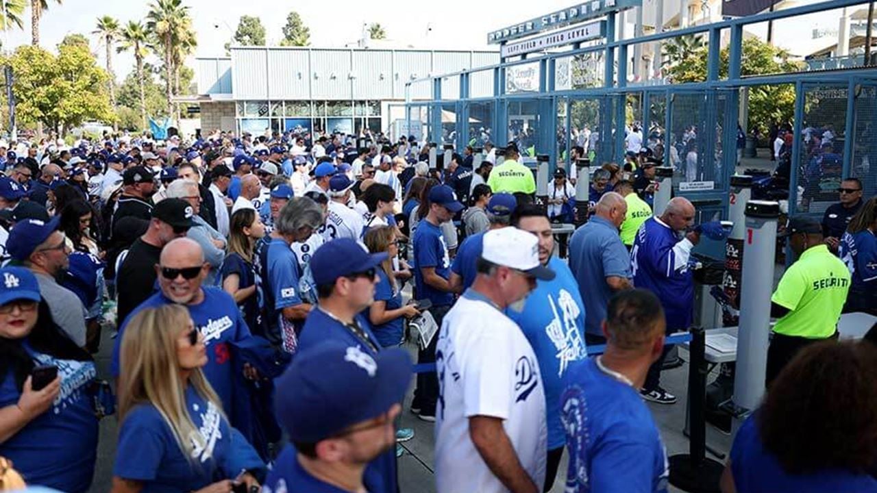 People enter Dodger Stadium before game three of the World Series between the Los Angeles Dodgers and the Toronto Blue Jays at Dodger Stadium on Monday, 27 October 2025 in Los Angeles, California