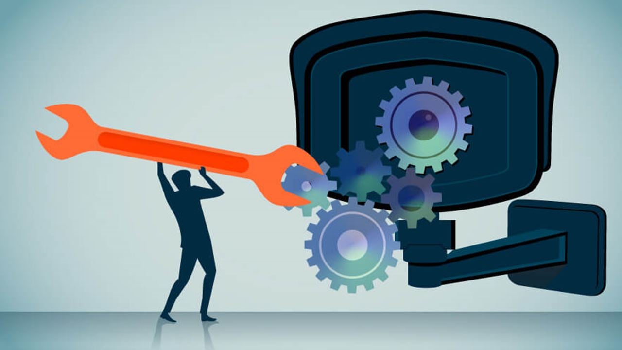 Illustration of a person using a large wrench to adjust gears inside a security camera, symbolizing the transformation and adaptability of hardware through software and innovation.