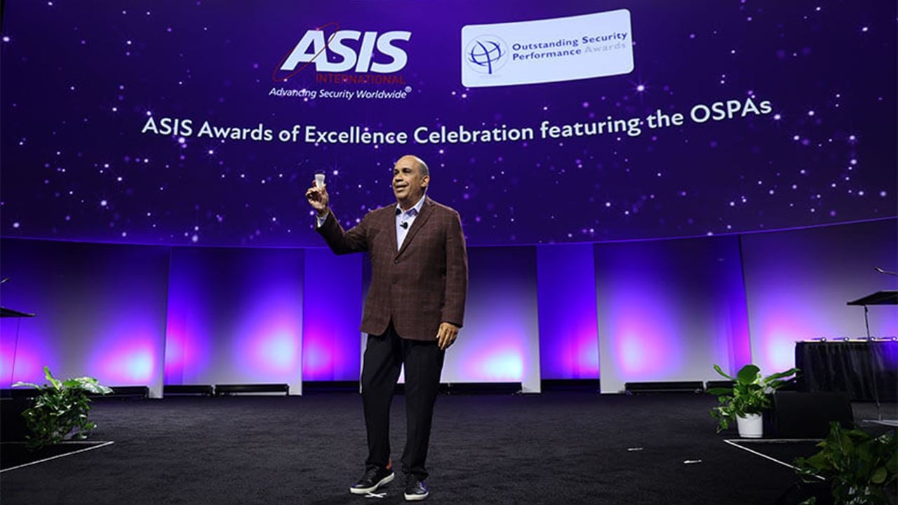 A photo of Joe Olivarez, Jr., 2025 president, ASIS International, toasting at the ASIS Awards ceremony.