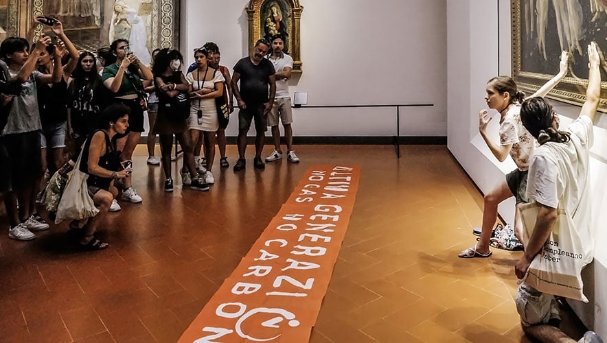 Protesters from the action group Ultima Generazione glue their hands to the glass covering Sandro Botticelli's La Primavera at Uffizi on July 22, 2022 in Florence, Italy. 