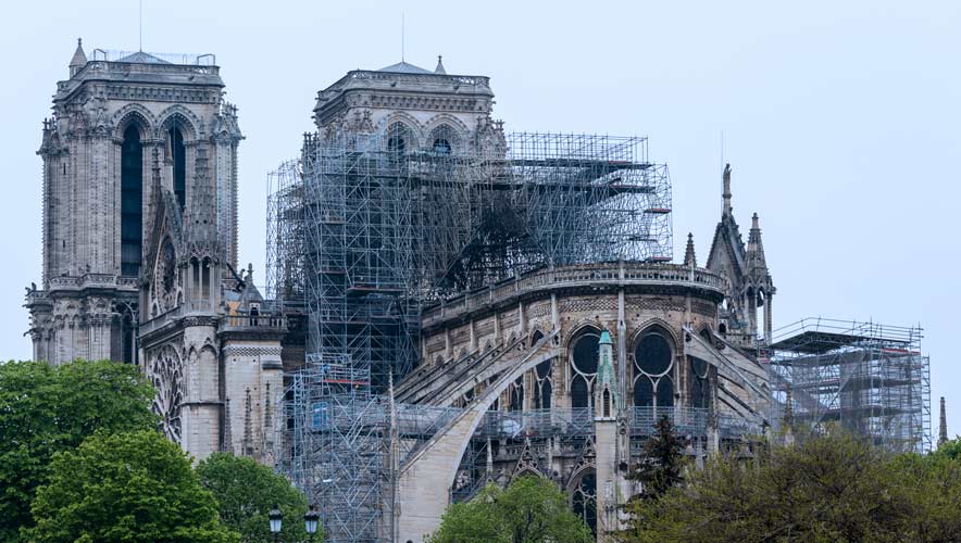 Notre Dame in Paris after the fire that destroyed a portion of the cathedral. Scaffolding rising in front of the historic structure. 