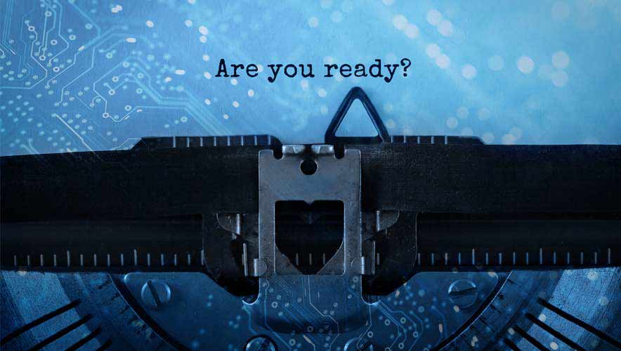 Close up photo of a typewriting with the phrase "Are you Ready" typed on a piece of paper. There is an light blue overlay with circuit imagery over the image. How to recover after a cybersecurity hack. 