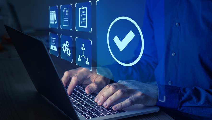 Photo illustration of a man's fingers typing on a laptop with a blue check mark icon above his hands.  Auditing your security system is a great way to help identify your building's threat assessments. 