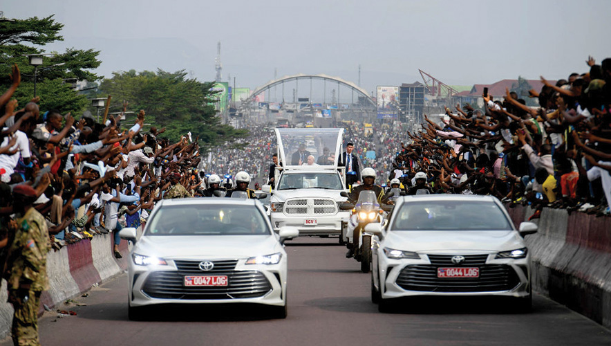 KINSHASA, CONGO - JANUARY 31: (EDITOR NOTE: STRICTLY EDITORIAL USE ONLY - NO MERCHANDISING) Pope Francis leaves the “Ndjili” International Airport in the popemobile to the Garden of the Palais de la Nation for a meeting with the authorities, civil society and diplomatic corps on January 31, 2023 in Kinshasa, Democratic Republic of Congo. Pope Francis has arrived in Kinshasa, as he begins his Apostolic Journey to the Democratic Republic of Congo, beginning his 40th Apostolic Journey abroad and his fifth Journey to Africa. The Holy Father will first visit the nation from 31 January to 3 February, following in the footsteps of Pope St. John Paul II, who visited there in 1980 and 1985. Photo by Vatican Media, Getty Images