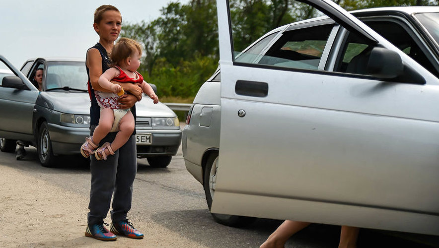 A young boy holds his sibling after fleeing Russian occupied regions. Zaporizhzhia continues to be a main crossing point for refugees fleeing the violence. 